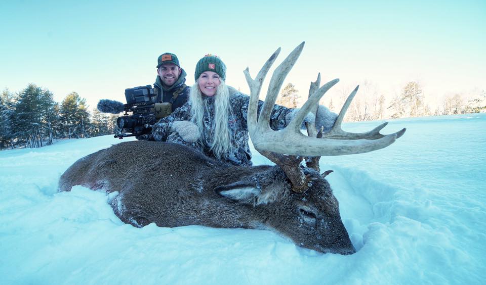 a couple celebrating a success or win after a guided whitetail hunt in wisconsin